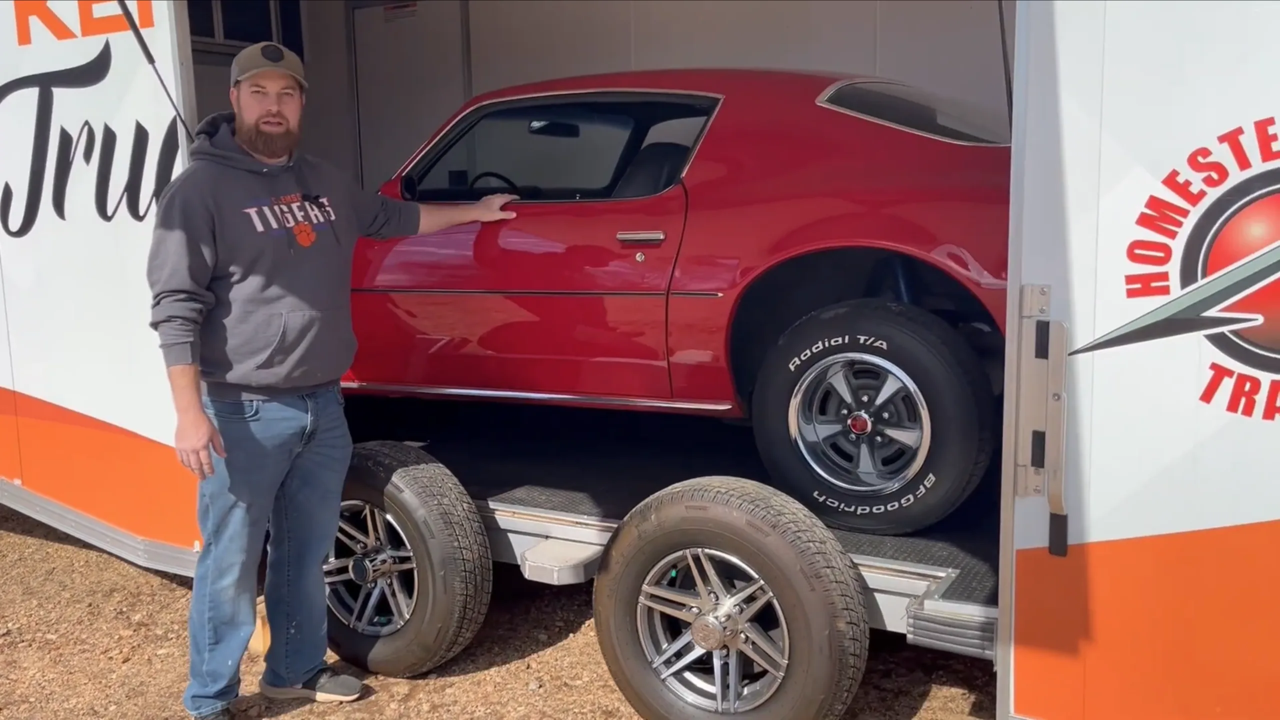 classic car inside enclosed trailer with gull wing